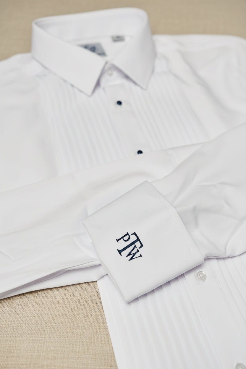 White dress shirt with a collar and buttons, featuring a brand label and monogram on a white background.